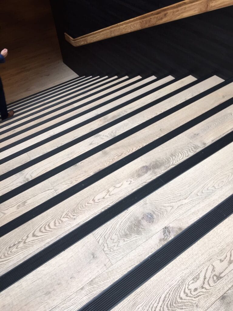 Black Anodised Aluminium Stair Nosings on a wood staircase.